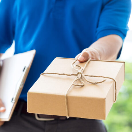 Delivery man holding a parcel box